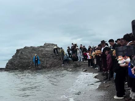 这是青海湖祭海,这是青海省海北藏族自治州的传统民俗 ,也是国家级非物质文化遗产之一。
青海湖祭海历史悠久,最早可追溯到汉代,唐代天宝年间唐玄宗赐封西海神(西王母)为广润公并遣使礼祭,此后这一活动延续下来。如今,每年农历七月十五是青海湖祭海的重要日子,届时,人们会在海滨搭建煨桑台,点燃松柏枝,袅袅青烟升腾而起,带着人们的祈愿飘向远方。在这过程中,喇嘛诵经祈福,藏、蒙古等各族群众投献哈达、白酒、五色粮食、酥油炒面等祭品,洁白的哈达象征着纯洁的敬意,白酒是对湖神的尊崇,五色粮食寓意着丰收,酥油炒面饱含着生活的质朴。众人还会向空中抛洒纸风马“隆达”,“隆达”带着人们对美好生活的向往在风中飞扬 。
在祭海的高潮环节,法师手持五色丝线缠裹的五谷包,率领手持各种法器的喇嘛仪仗队,以及吹着藏唢呐和法号、头戴鹿首、牛首面具的鹿神、牛神和其他地方神拥向湖岸。法师站在岸边朝着湖水念诵咒语,祭祀者则向湖中投掷苹果、橘子、烤馕、用谷类制作而成的生态保瓶等祭物,表示对海神的崇拜,同时热切祈祷海神保佑众生幸福、人畜兴旺、五谷丰登、国泰民安 。
祭海仪式结束后,热闹还在继续,湖边会举行赛马、赛牛、射箭等充满激情与活力的体育活动,骑手们在赛场上驰骋,展示着勇敢与力量;也会有跳神、佐斗候、桑德舞、吉祥鹿舞等具有浓郁民族风情的表演,舞者们用优美的舞姿传达着对生活的热爱和对未来的憧憬,使祭海活动不仅充满神秘色彩,更具有娱乐和文化内涵,促进了各民族团结融合发展 。