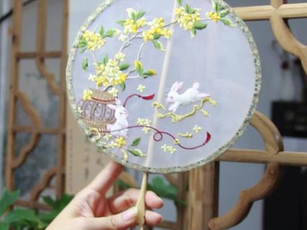 手把手教你制作一把非遗团扇 材料准备
- 圆形扇框(竹制或木制,直径可选20-30cm)
- 刺绣纱面(真丝或仿真丝材质,选半透质感更出效果)
- 剪刀、UHU胶水、热熔胶
- 小夹子
- 宋锦边(匣锦)
- 扇柄(木质扇柄,提前打孔便于后期组装)
- 流苏、装饰珠子(可选,用于扇柄装饰)
步骤详解
1. 挑选制作好的绣片
2. 封扇面
- 将绣好的纱面平整地绷在圆形扇框上,用小夹子固定边缘,确保纱面紧绷无褶皱。
- 把扇柄与扇框连接,可借助胶水固定。
3. 安装扇柄
4. 封扇底
5. 贴宋锦边条
6. 装饰收尾
- 在扇柄处穿上流苏、装饰珠子提升整体精致度。
小贴士
- 纱面较轻薄,操作时注意力度,避免扯坏纱面。
快动手做一把属于自己的中秋主题团扇吧,无论是自用搭配汉服,还是作为非遗手作礼物,都超有意义~
#龙姐姐的雅集 #在中秋向月亮许愿 #百young非遗计划 #这是我的非遗献礼 #中秋月满人团圆