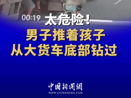 太危险!男子推着孩子从大货车底部钻过